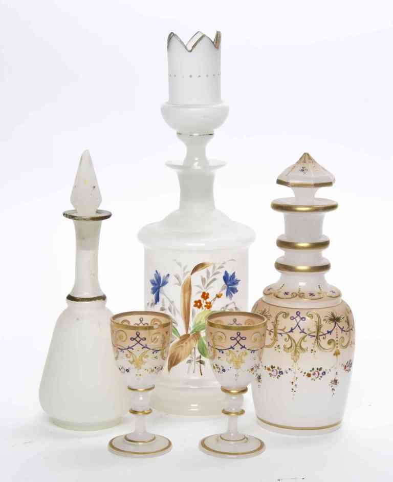 A Collection of Three Opaline Glass Bottles, Heig: A Collection of Three Opaline Glass Bottles, each with stopper, of various forms and decoration, together with two cordials. Height of tallest 10 inches. Property from the Estate of Norma B. Harris, C