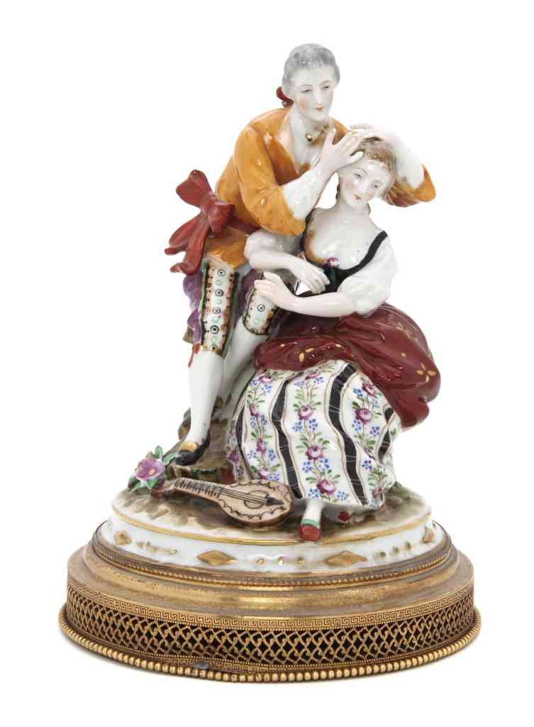 A Continental Porcelain Figural Group, Height 8 1: A Continental Porcelain Figural Group, depicting a courting couple with a lute at their feet, set on a gilt metal base. Height 8 1/8 inches.