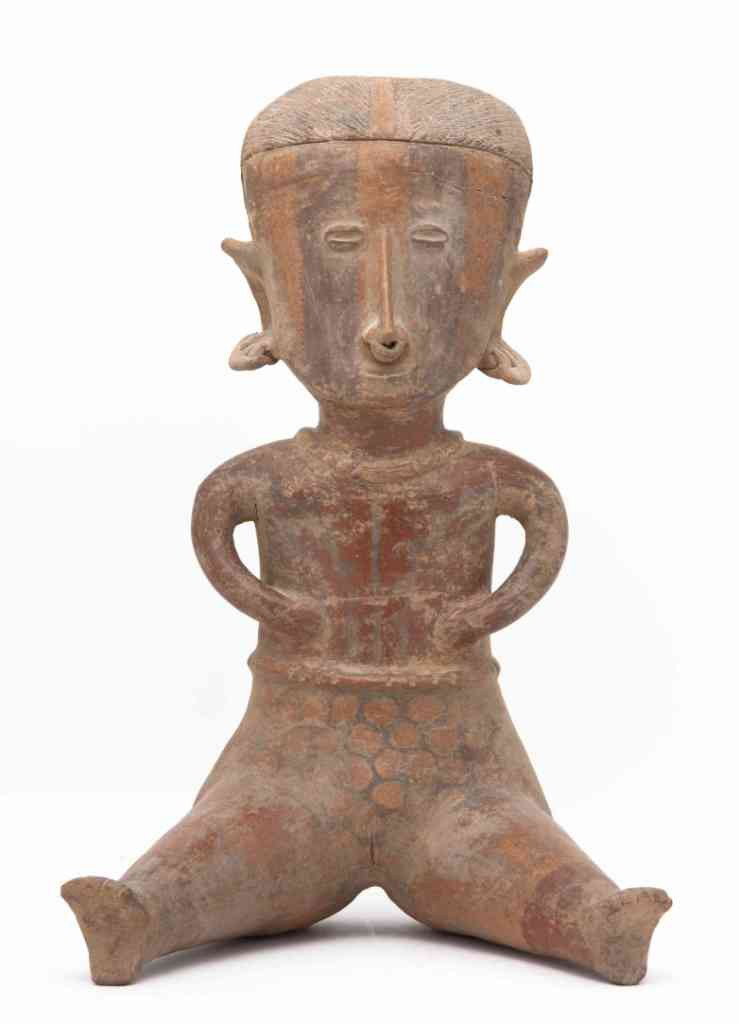 A Nayarit Pottery Burial Figure, Height 17 inches: A Nayarit Pottery Burial Figure, the female figure depicted seated wearing multiple earrings and nose ring, with arms at sides. Height 17 inches. Property from the Collection of Mr. and Mrs. John F. M