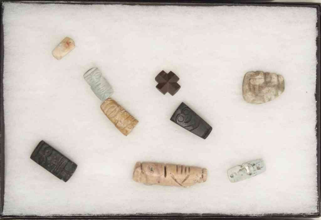 A Collection of Nine Cases Relating to the Mayan : A Collection of Nine Cases Relating to the Mayan Culture, comprising beads, shells, carved figures and others. Length of longest shell 7 1/2 inches. Southern Illinois University Edwardsville Foundatio