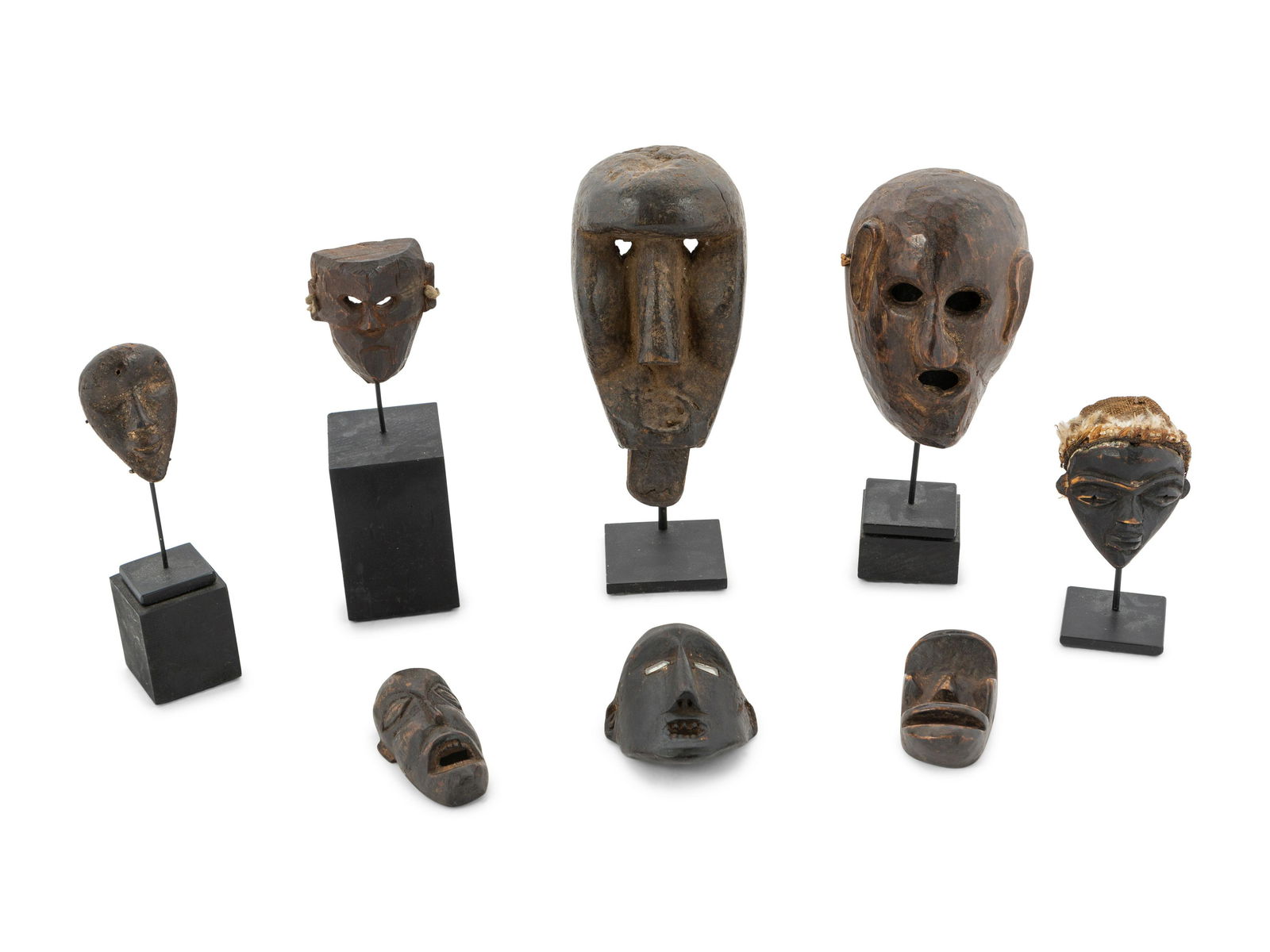 A Group of Eight Miniature Ethnographic Carved Masks (1 of 4)