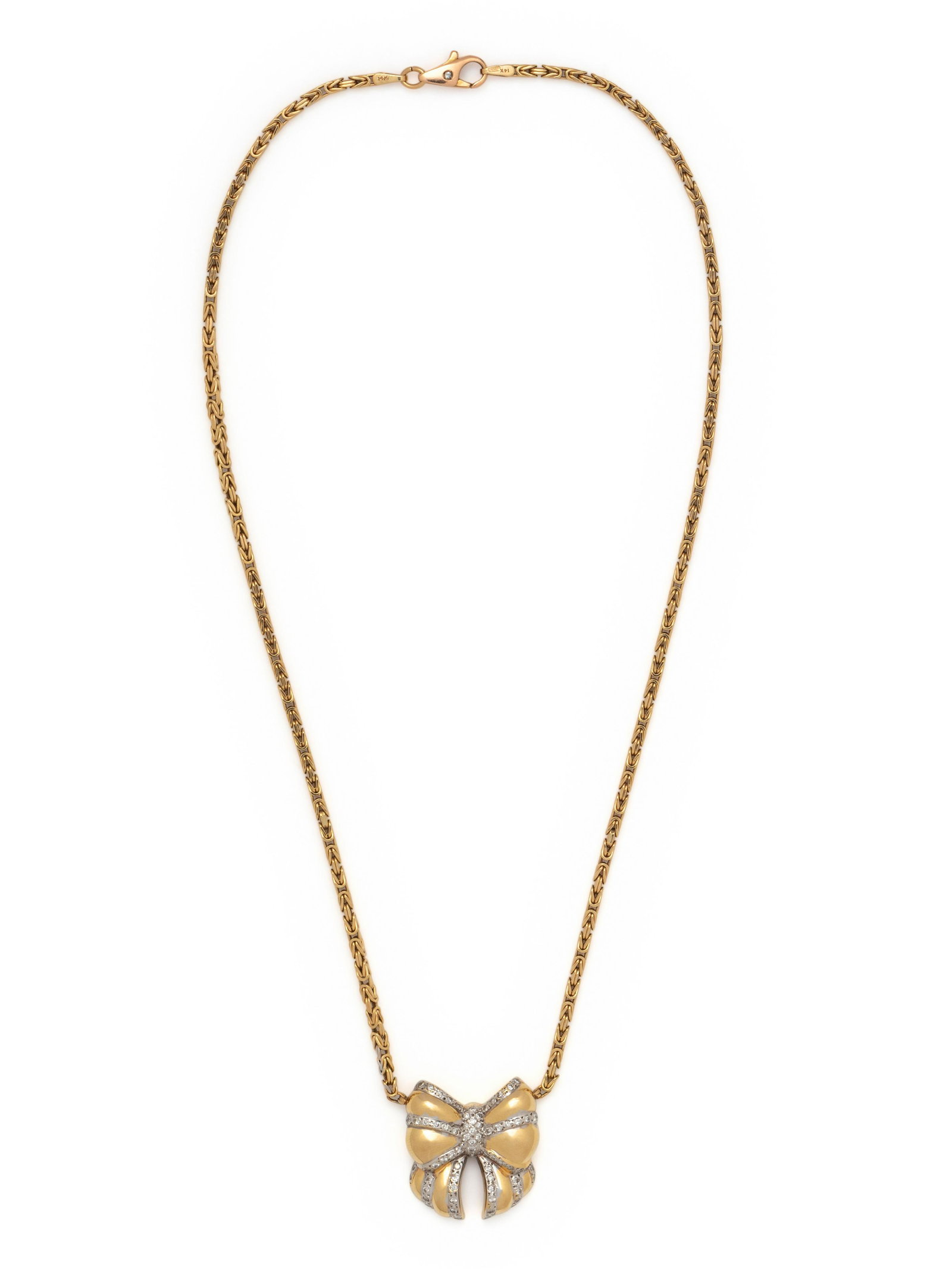 YELLOW GOLD AND DIAMOND BOW NECKLACE: YELLOW GOLD AND DIAMOND BOW NECKLACE Consisting of a Byzantine link chain measuring approximately 2.00 mm wide with central bow containing 69 round brilliant cut diamonds weighing approximately 0.55 c