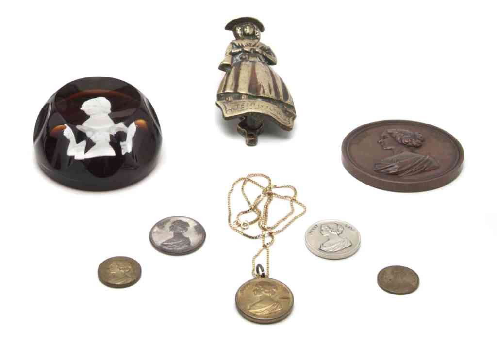 A Collection of Articles Pertaining to Jenny Lind, : A Collection of Articles Pertaining to Jenny Lind, comprising a brass door knocker, a sulfite paperweight and six medals. Height of first 4 3/4 inches.
