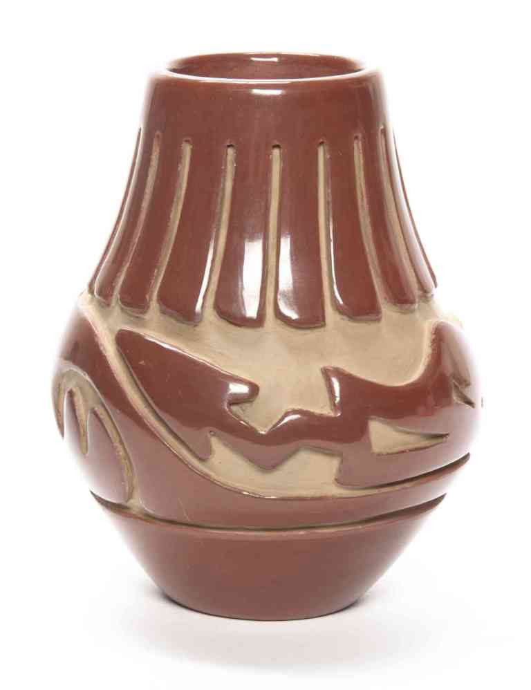 A Santa Clara Redware Pottery Vase, Stella Chavarri: A Santa Clara Redware Pottery Vase, Stella Chavarria, of baluster form, with stylized feather and carved Awanyu spirit decoration. Height 5 1/8 inches. Property from the Estate of John Haight, Arlingt