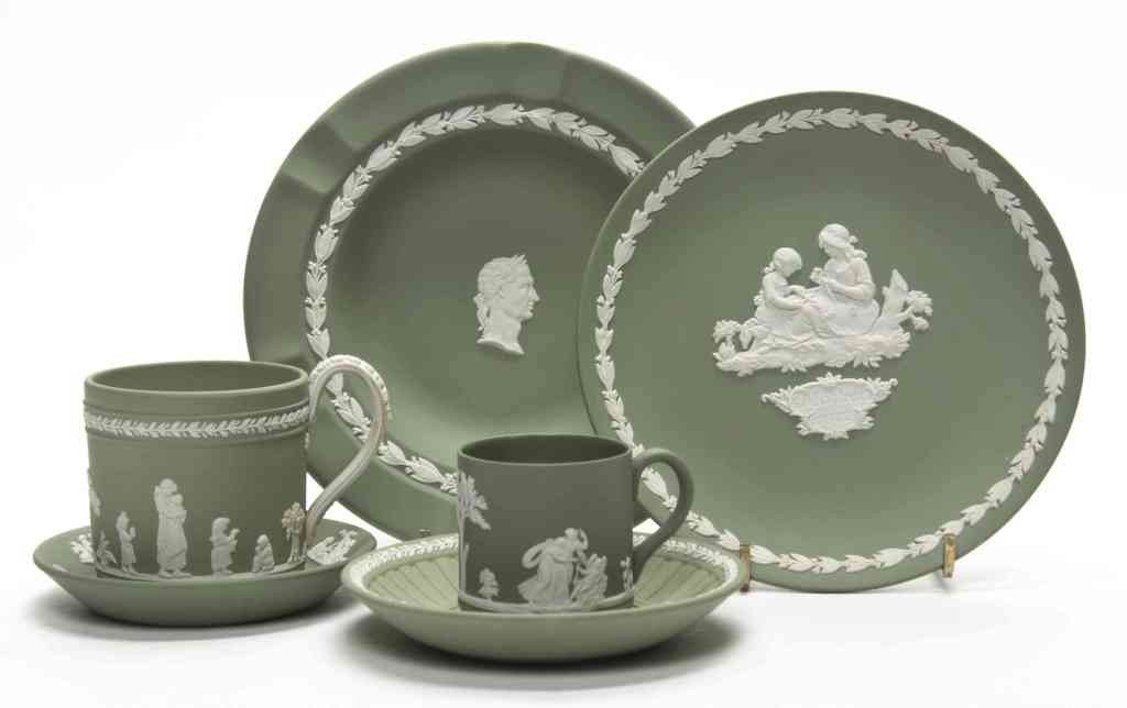 A Collection of Four Wedgwood Jasperware Articles,: A Collection of Four Wedgwood Jasperware Articles, each having white decoration on a green ground, comprising a plate, an ashtray and two cups and saucer sets, marked Wedgwood, Made in England. Diamet