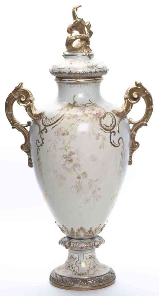 A Royal Bonn Porcelain Covered Urn, Height 31 inch: A Royal Bonn Porcelain Covered Urn, having a gilt Rococo style finial on the lid over the baluster form body decorated with flowers within cartouches set on a light blue reserve, with applied gilt fol