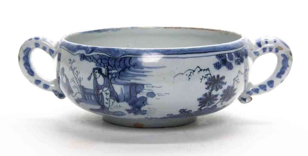 A Delft Faience Accouchement Bowl, Diameter 9 3/4: A Delft Faience Accouchement Bowl, having blue and white Chinoiserie decoration, double handles and interior strainer, raised on a circular foot. Diameter 9 3/4 inches. Property from the Estate of Nor