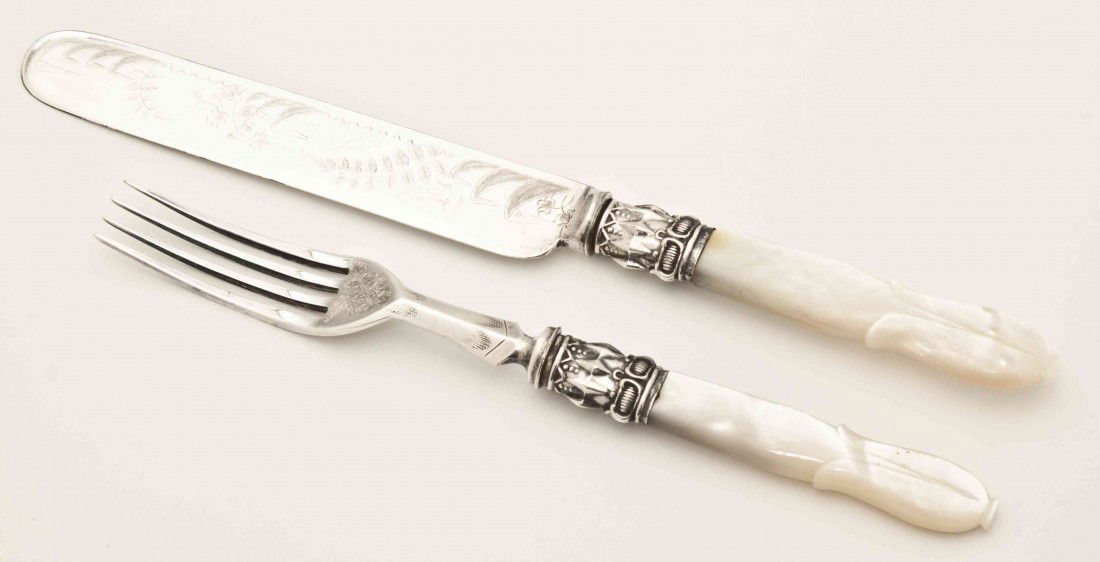 An English Cased Silverplate and Mother-of-Pearl F: An English Cased Silverplate and Mother-of-Pearl Fish Service, comprising 12 forks and 12 knives with engraved Aesthetic decoration and floriform carved handles, set in a mahogany case. Width of case
