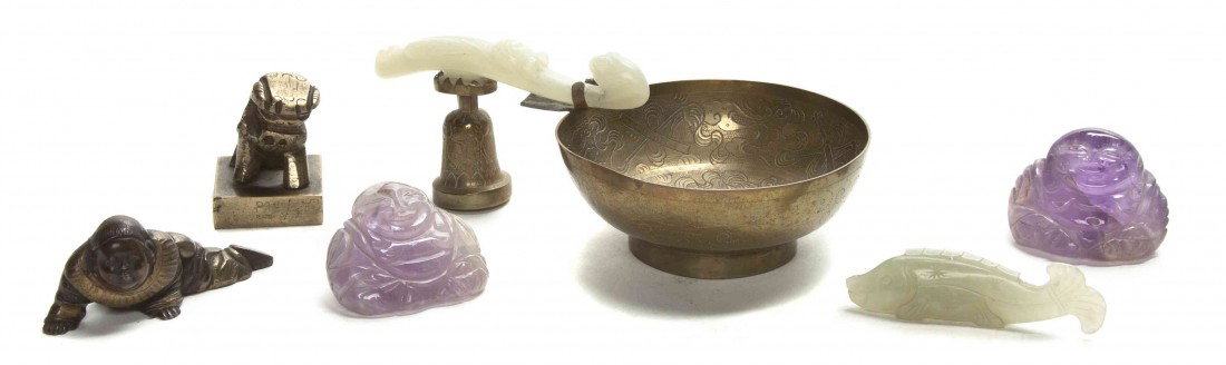 A Group of Chinese Jade and Decorative Articles, W: A Group of Chinese Jade and Decorative Articles, comprising a jade fish, a jade garment hook mounted as a handle, two carved amethyst hotei, a bronze toggle and a bronze chop with a fu dog finial. Wid
