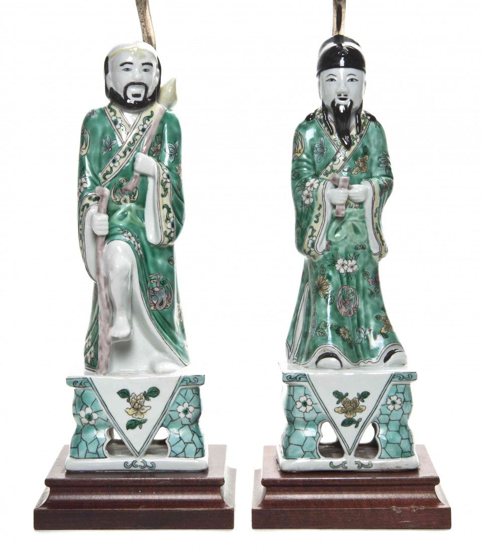 A Pair of Chinese Glazed Ceramic Figures, Height o: A Pair of Chinese Glazed Ceramic Figures, each depicted in green robes, set on rectangular bases and mounted as lamps with hardstone finials. Height overall 26 1/4 inches.