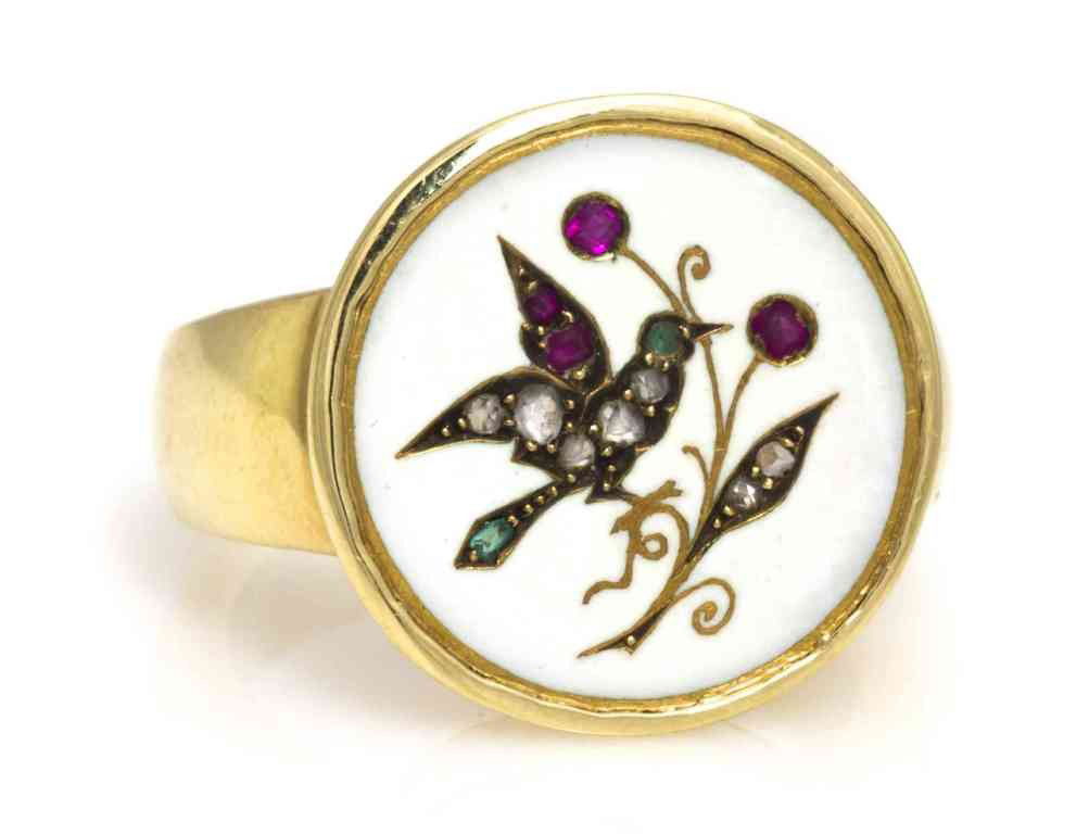 A Yellow Gold and 17th Century Ivory Button Ring, 9: A Yellow Gold and 17th Century Ivory Button Ring, button consisting of a bird and leaf motif outline in gold containing several rose cut diamonds, rubies and emeralds within the ivory surround. 9.00 d