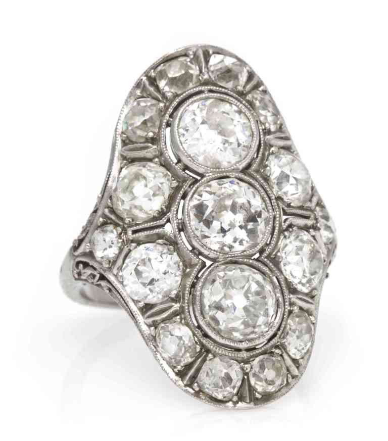 An Edwardian Platinum and Diamond Ring, 5.20 dwts.: An Edwardian Platinum and Diamond Ring, containing one old European cut diamond weighing approximately 1.00 carat, one old European cut diamond weighing approximately 0.85 carat, one old European cut 
