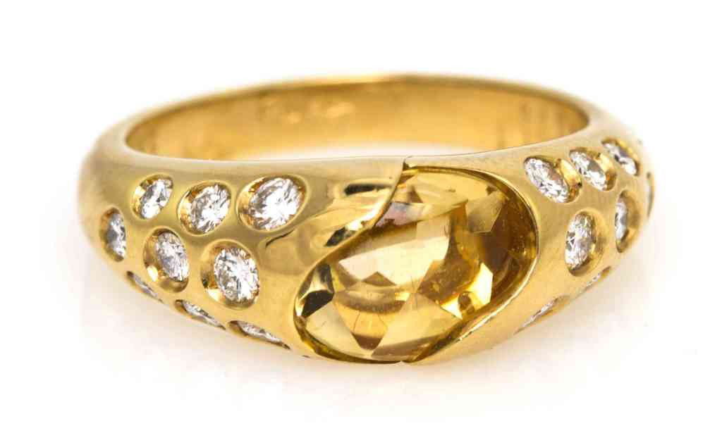 An 18 Karat Yellow Gold, Citrine and Diamond Ring,: An 18 Karat Yellow Gold, Citrine and Diamond Ring, Chaumet, containing one mixed cut citrine and 18 round brilliant cut diamonds weighing approximately 0.25 carat total. Stamp: CHAUMET 360154. Proven