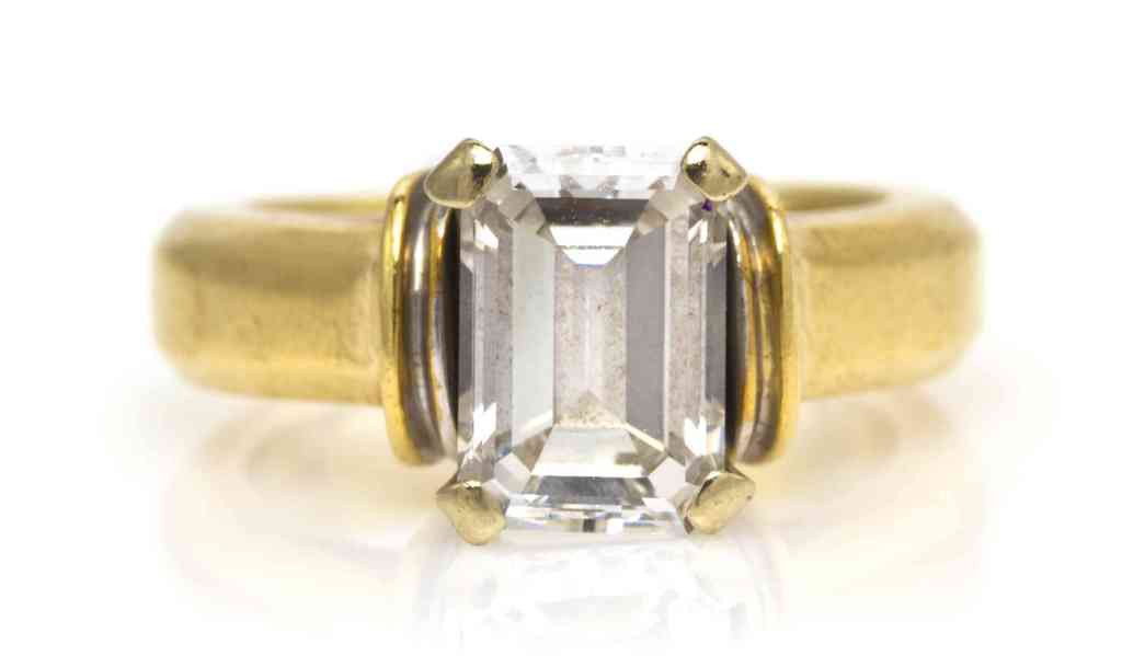 A 14 Karat Gold and Diamond Solitaire Ring, 6.35 d: A 14 Karat Gold and Diamond Solitaire Ring, containing one octagonal step cut diamond weighing approximately 2.14 carats within a white gold double gallery basket setting and a yellow gold beveled edg