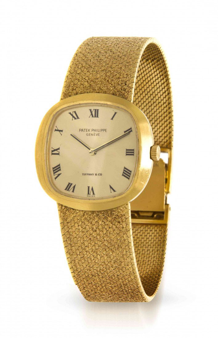 An 18 Karat Yellow Gold Wristwatch, Patek Philippe: An 18 Karat Yellow Gold Wristwatch, Patek Philippe for Tiffany & Co., 27.00 x 26.00 mm case dimensions, brushed yellow gold dial signed PATEK PHILIPPE GENEVE at 12 o'clock and TIFFANY & CO at 6 o'cloc
