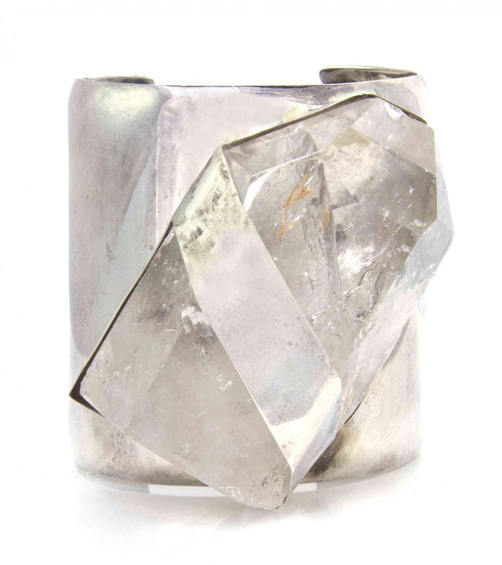 A Sterling Silver and Quartz Cuff Bracelet, Rebecc: A Sterling Silver and Quartz Cuff Bracelet, Rebecca Collins for Neiman Marcus, 1988, consisting of a polished quartz crystal within a band and collet setting atop a cuff bracelet measuring approximate