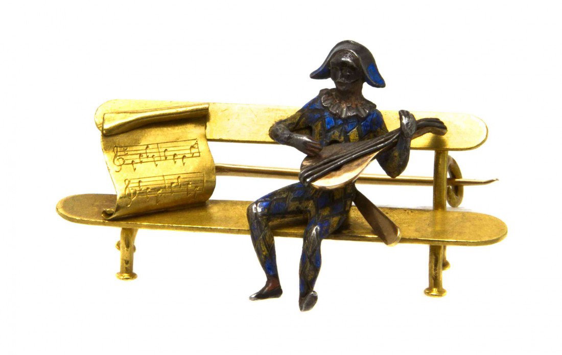 A Victorian 18 Karat Yellow Gold, Silver and Ename: A Victorian 18 Karat Yellow Gold, Silver and Enamel Brooch, French, depicting a gentleman seated on a bench playing a lute opposite a scroll of sheet music. Stamp: (maker's mark) (French assay marks).