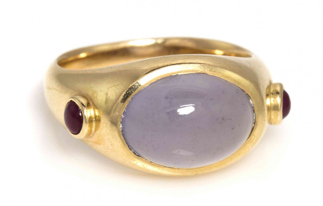 A 14 Karat Yellow Gold, Chalcedony and Ruby Ring,: A 14 Karat Yellow Gold, Chalcedony and Ruby Ring, containing one oval cabochon cut blue chalcedony weighing approximately 7.50 carats and two round cabochon cut rubies. Stamp: 14K. 4.70 dwts.