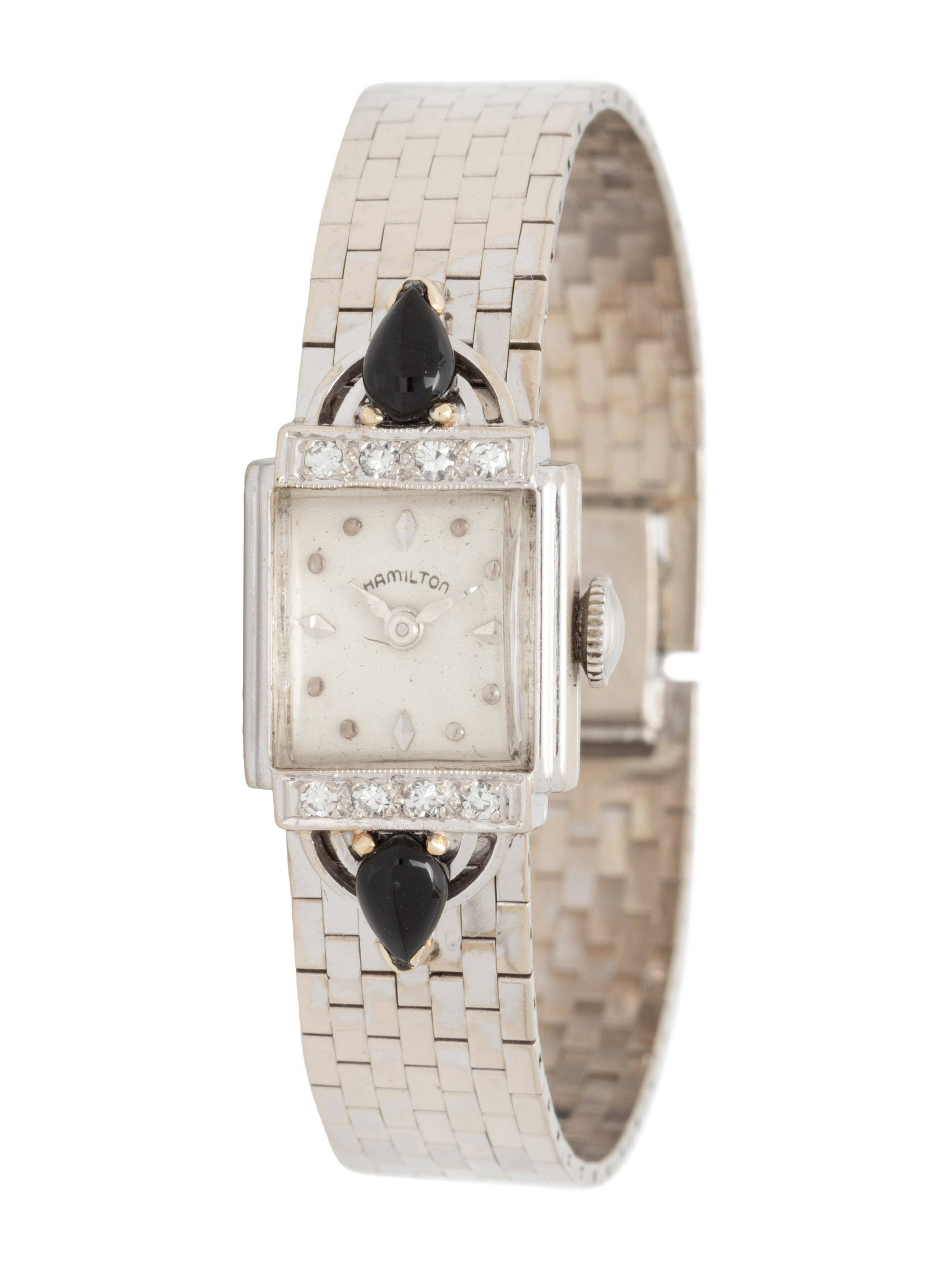 HAMILTON, 14K WHITE GOLD, ONYX AND DIAMOND WRISTWATCH: HAMILTON, 14K WHITE GOLD, ONYX AND DIAMOND WRISTWATCH 17.00 x 14.00 mm case dimensions exclusive of lugs, the bezel and lugs containing two pear onyx cabochons and eight single cut diamonds, off white