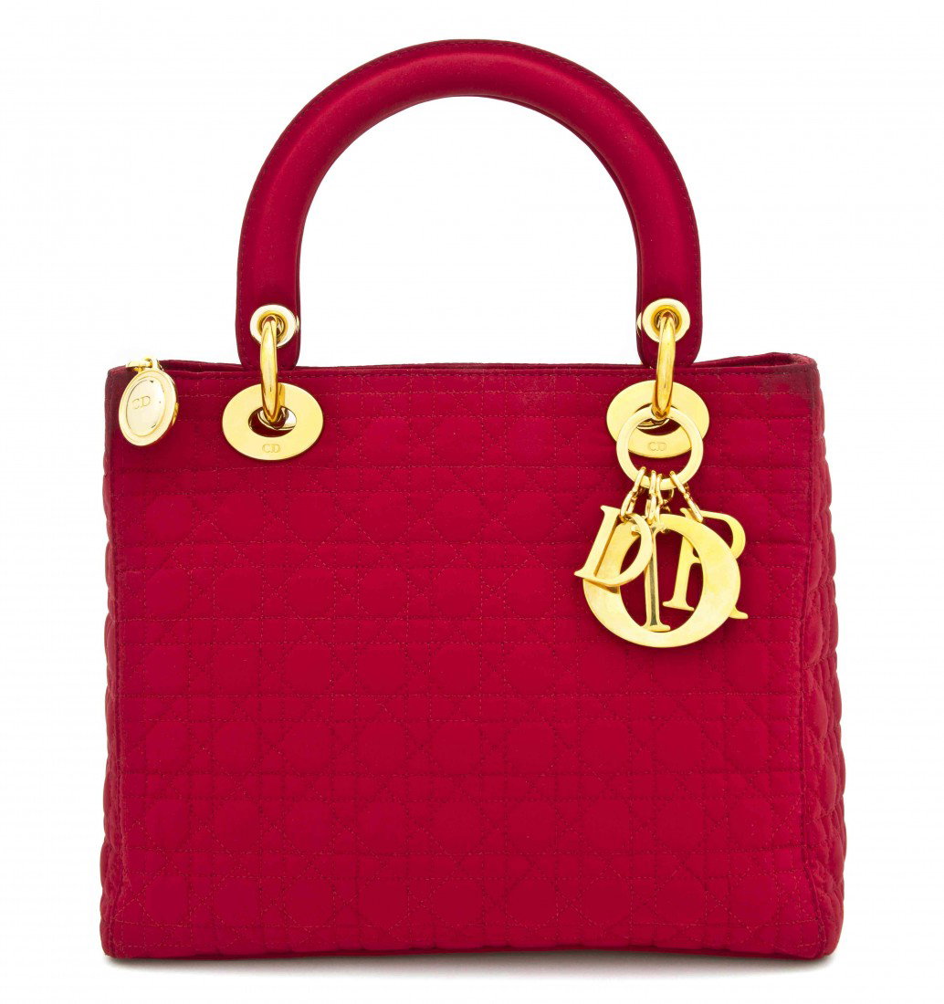 A Christian Dior Red Silk Bag, 10 x 7 inches.: A Christian Dior Red Silk Bag, with goldtone hardware, 'DIOR' charm keychain attached. Stamped: Christian Dior. 10 x 7 inches.