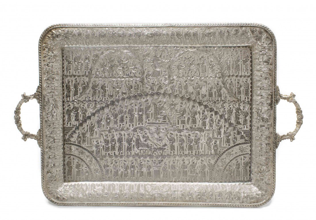 An Iranian Silver Serving Tray, Width of tray betw: An Iranian Silver Serving Tray, of rectangular form with two handles, depicting a historical scene from ancient Persia; approximate weight 88.50 ozt. Width of tray between handles 24 3/4 inches.