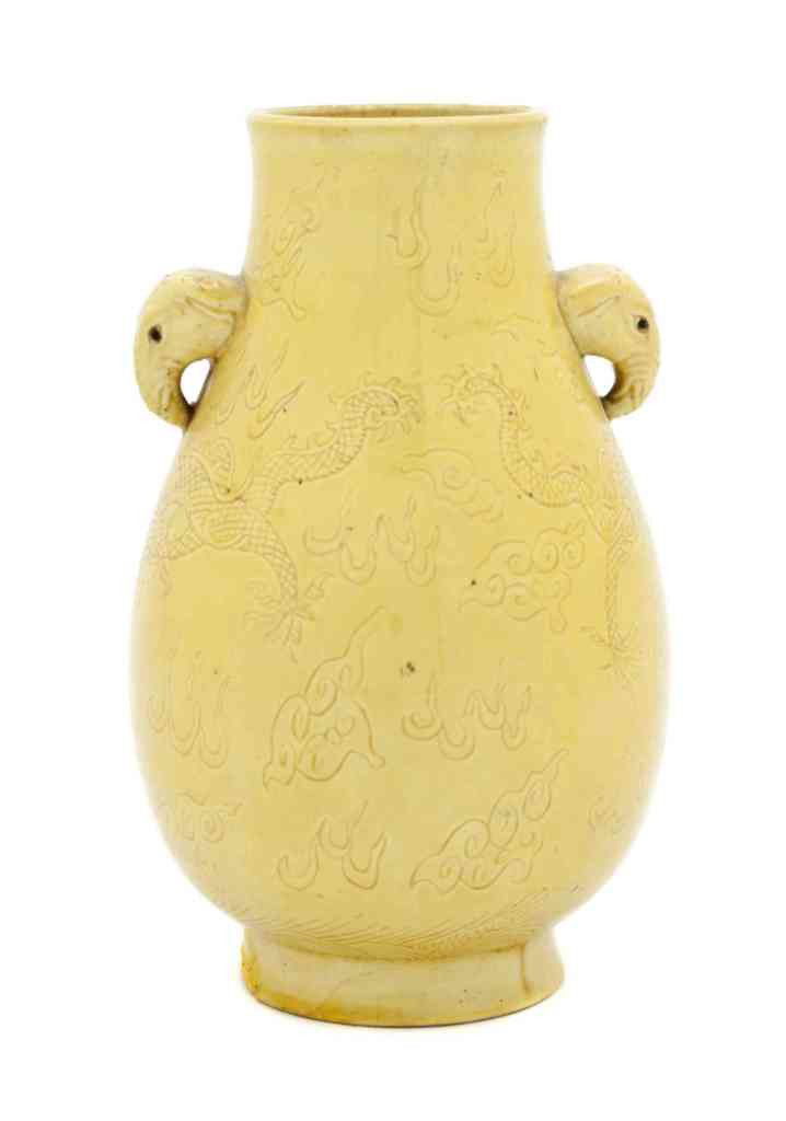 A Chinese Hu-Form Vase, Height 8 inches.: A Chinese Hu-Form Vase, having a yellow glaze with dragons chasing a flaming pearl and elephant handles. Height 8 inches. Property from the Collection of Thomas H. Hughes Trust, Sarasota, Florida