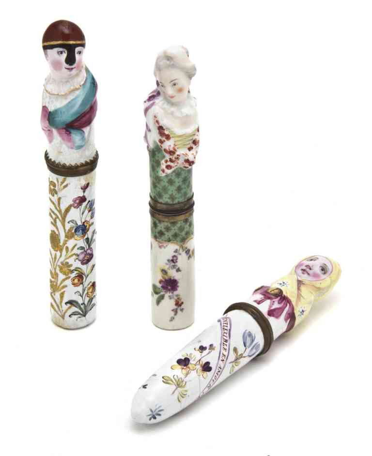 Two English Enameled Figural Needle Cases, Height o: Two English Enameled Figural Needle Cases, one depicting a man, the other a woman, together with a porcelain example. Height of tallest 5 1/4 inches. Property from the Estate of Ruth Regenstein, Chica