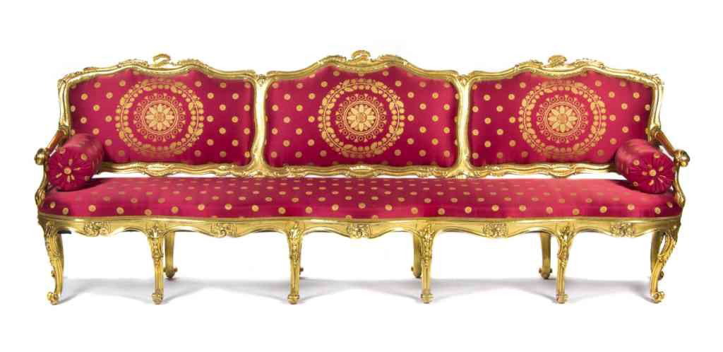 A Louis XV Style Triple-Back Giltwood Canape, Heig: A Louis XV Style Triple-Back Giltwood Canape, 19th century, having a carved crest over the upholstered back and seat within a foliate carved frame, raised on cabriole legs ending in scrolled toes. Hei