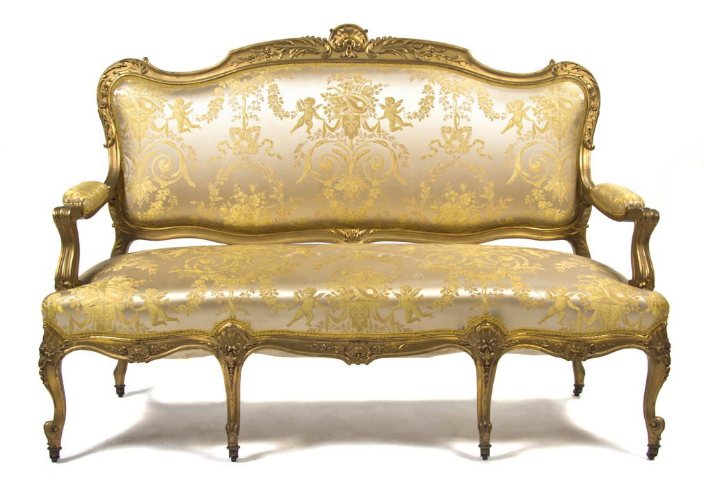 A Louis XV Style Giltwood Settee, Height 46 x widt: A Louis XV Style Giltwood Settee, having a shell carved crest over the upholstered back, arms and seat, raised on cabriole legs ending in scrolled toes and casters. Height 46 x width 63 x depth 31 inc