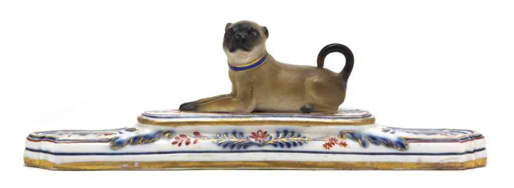 A Meissen Porcelain Paperweight, Width 7 3/4 inche: A Meissen Porcelain Paperweight, depicting a recumbent pug on a stepped base, having crossed swords mark in underglaze blue. Width 7 3/4 inches. Property from the Collection of Marilyn Raskin, Wayzata