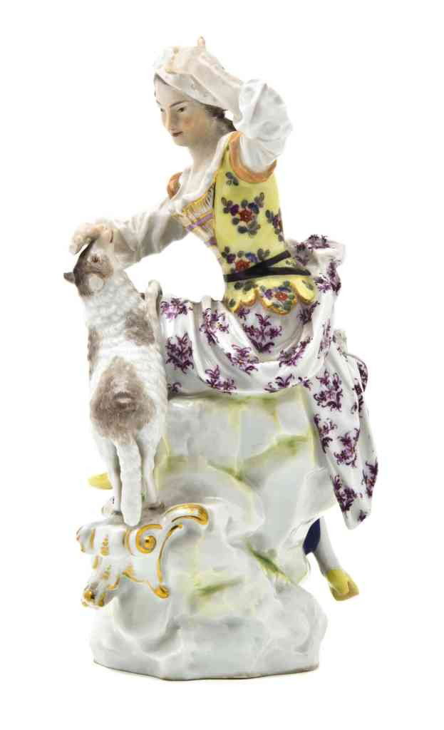 A Meissen Porcelain Figural Group, Height 8 5/8 in: A Meissen Porcelain Figural Group, depicting a shepherdess with sheep, having crossed swords mark in underglaze blue, impressed 144, incised 1323. Height 8 5/8 inches.