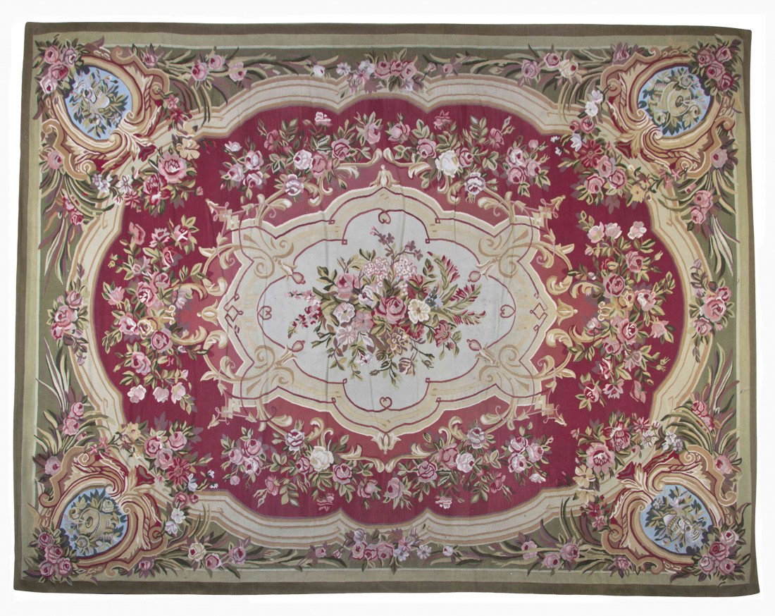 An Aubusson Wool Carpet, 11 feet 10 inches x 8 fee: An Aubusson Wool Carpet, centered with a foliate medallion within conforming floral borders. 11 feet 10 inches x 8 feet 10 inches.