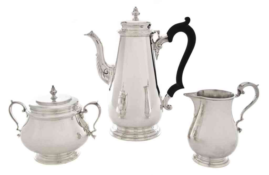 An English Sterling Silver Coffee Service, Garrard: An English Sterling Silver Coffee Service, Garrard & Co., London, 1814, including coffee pot, covered sugar and creamer, the coffee pot with leaf decoration to spout and ebonized wood handle, each pie