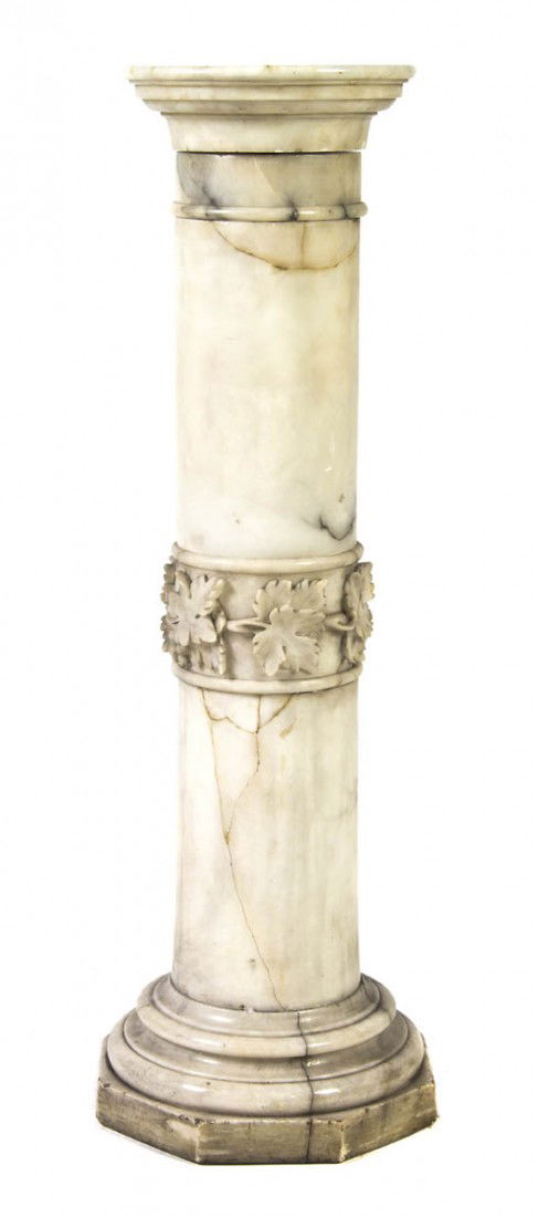 A Continental Alabaster Pedestal, Height 41 inches: A Continental Alabaster Pedestal, of columnar form having central band of grape leaves raised on a stepped circular base further raised on an octagonal base. Height 41 inches.