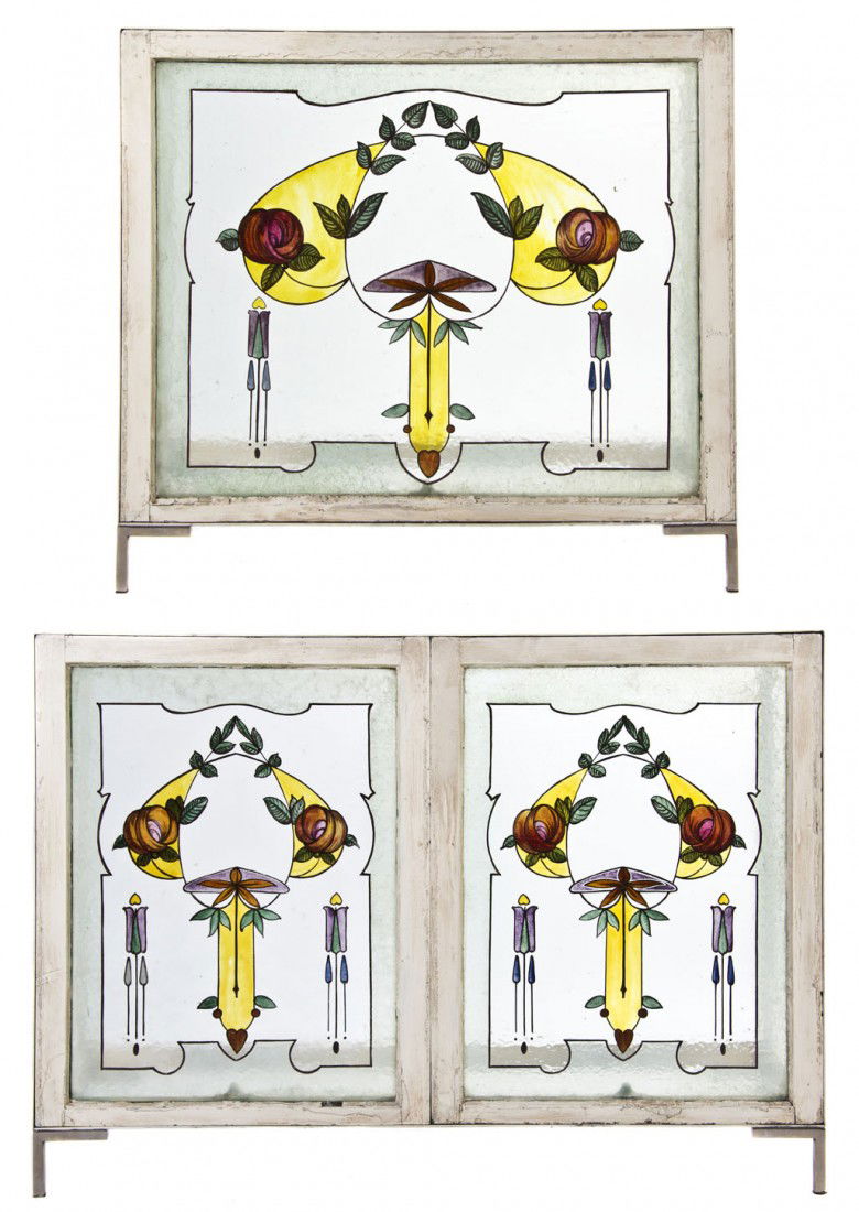 A Near Pair of Arts and Crafts Stained Glass Windo: A Near Pair of Arts and Crafts Stained Glass Window-Inset Console Tables, each having a rectangular glass top over the painted steel frame enclosing windows with floral and geometric decoration. Heigh