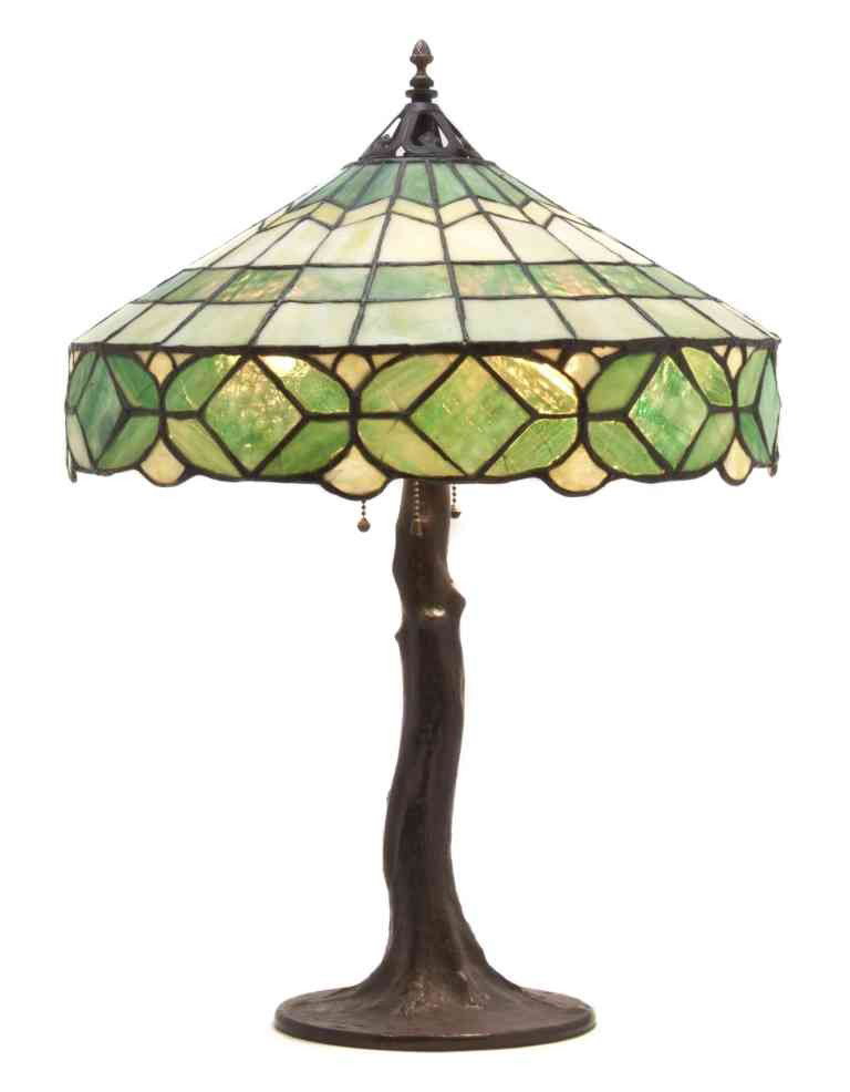 A Handel Leaded Glass Table Lamp, Height overall 2: A Handel Leaded Glass Table Lamp, having a conical geometric shade raised on a tree trunk form base. Height overall 25 1/2 x diameter of shade 18 1/2 inches. Property from O'Hara's Gallery, Chicago, I