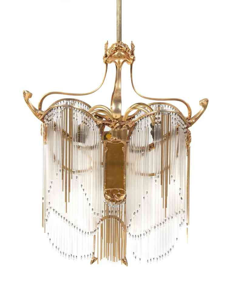 A French Art Nouveau Gilt Bronze and Glass Rod Ch: A French Art Nouveau Gilt Bronze and Glass Rod Chandelier, after a Model by Hector Guimard, of stylized foliate form, hung with glass and bronze rods, having impressed glyph. Height 25 1/2 inches.