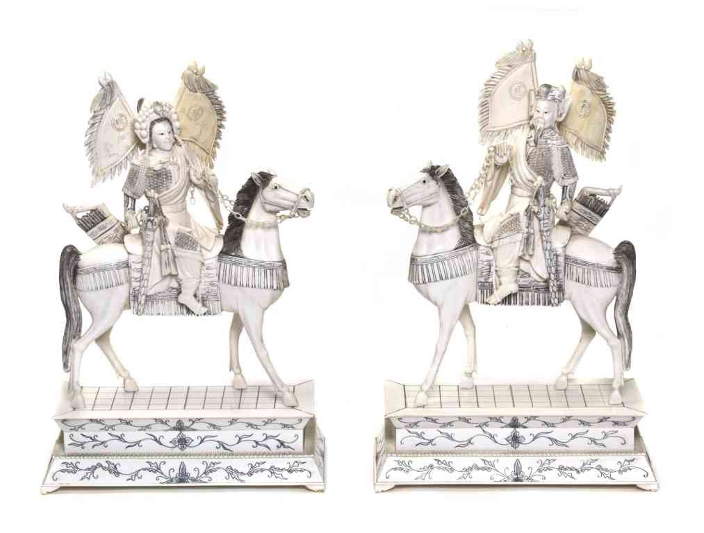 A Pair of Carved Ivory Emperor and Empress on Horse: A Pair of Carved Ivory Emperor and Empress on Horseback, depicting the figures in full armor with pendants waving behind them, with free-moving chains and raised atop an ivory veneered rectangular bas