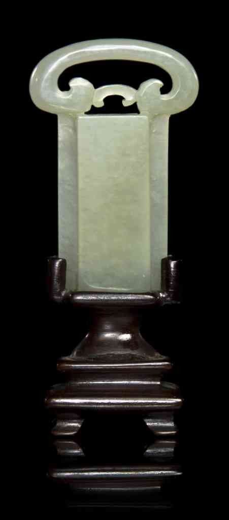 A White Jade Buckle, Height 2 1/2 inches.: A White Jade Buckle, having rectangular slot with carved loop at top. Height 2 1/2 inches. Property from the Estate of Dr. Joseph and Donna Lee Boggs, Chicago, Illinois