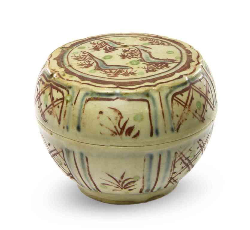 An Anamese Enameled Circular Box and Cover, Diamet: An Anamese Enameled Circular Box and Cover, 14th/15th century, the top having painted decoration of a hilly landscape above lappet panels encircling the sides of the cover and box. Diameter 3 1/4 inch
