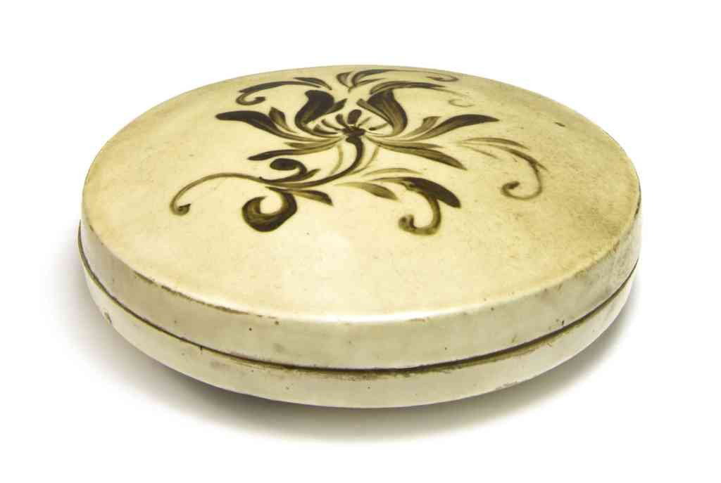 A Cizhou Painted Circular Box and Cover, Diameter : A Cizhou Painted Circular Box and Cover, Song/Jin Dynasty, the cover having painted decoration in brown over a white slip with sprays of peony blossoms. Diameter 4 1/2 inches. Property from a Private 