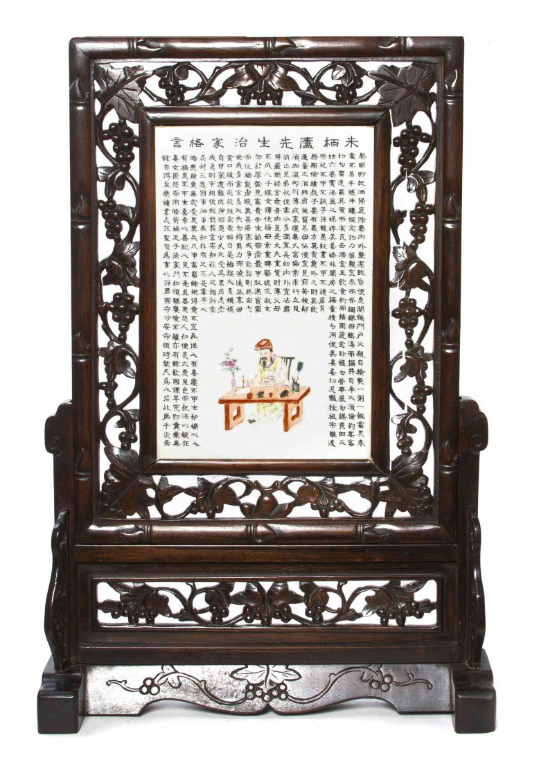 A Chinese Porcelain Inset Table Screen, Height of : A Chinese Porcelain Inset Table Screen, of rectangular form, with enameled decoration of a landscape, raised upon a carved wood stand. Height of porcelain 15 5/8; height overall 32 inches.