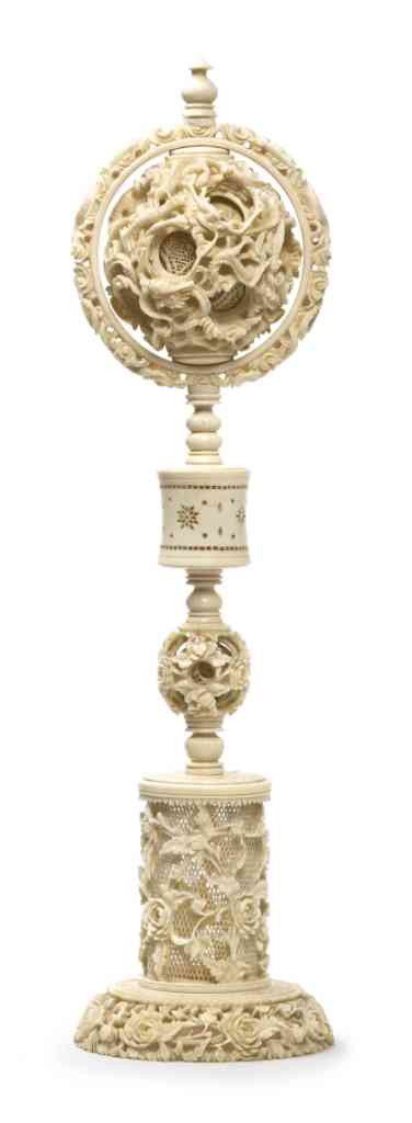 A Chinese Carved Ivory Puzzle Ball on Stand, Heigh: A Chinese Carved Ivory Puzzle Ball on Stand, the main ball at top carved with sinuous dragons, contained in a fixed ring above the turned standard containing another small ball and pierced cylinder, t
