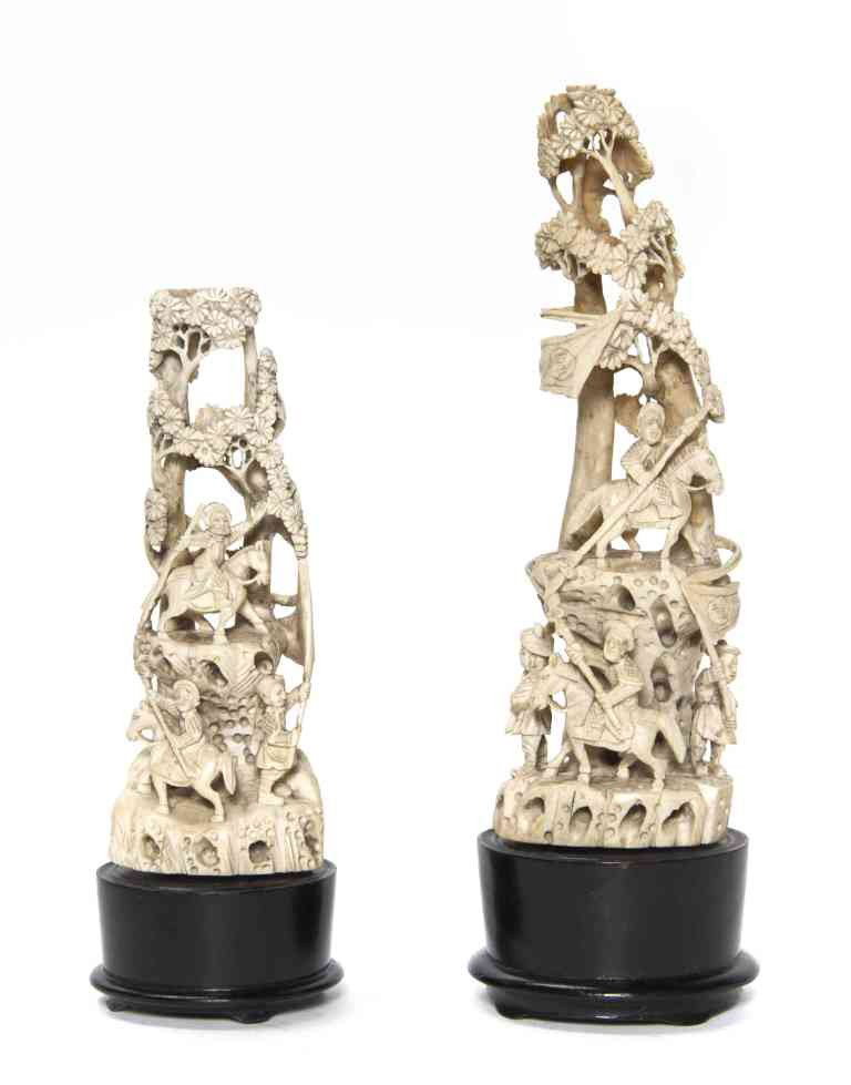 A Group of Two Ivory Carvings, Height of tallest 8: A Group of Two Ivory Carvings, each of tusk form and pierce carved depicting a horseback figure surrounded by trees. Height of tallest 8 1/4 inches.