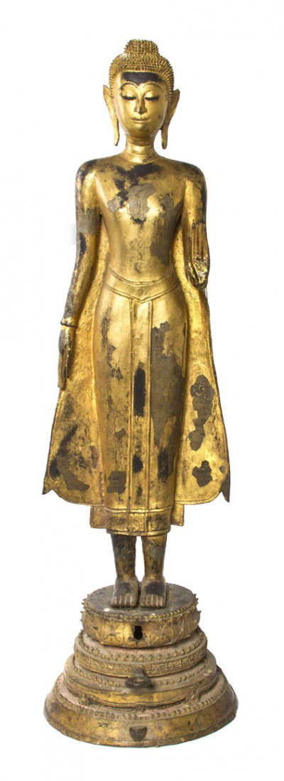 A Southeast Asian Gilt Figure of Buddha, Height 45: A Southeast Asian Gilt Figure of Buddha, depicted in a standing pose with foliate decoration throughout the robe and raised upon a stepped lotus-form base. Height 45 inches. Property from the Collecti