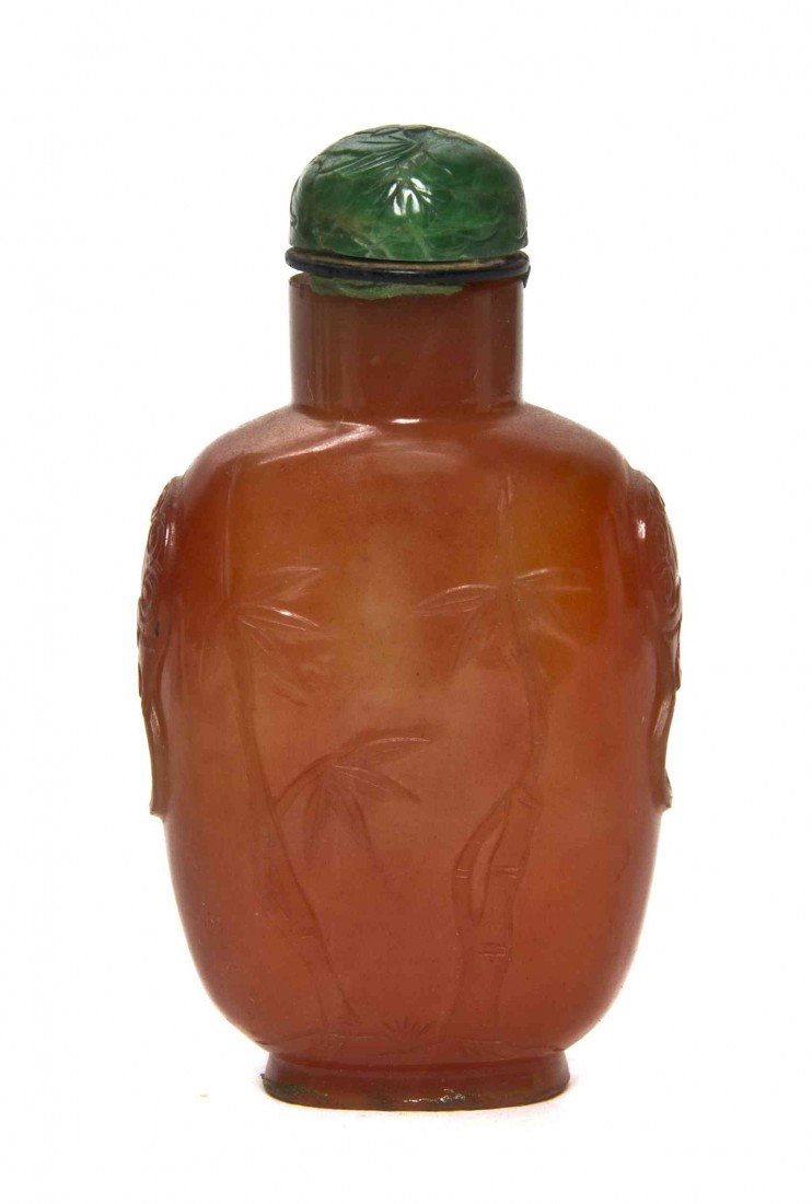 A Carnelian Snuff Bottle, Height 2 5/8 inches.: A Carnelian Snuff Bottle, with lightly carved decoration of bamboo, with jadeite stopper carved with a flying goose. Height 2 5/8 inches. Property from the Estate of Dr. Joseph and Donna Lee Boggs, Ch