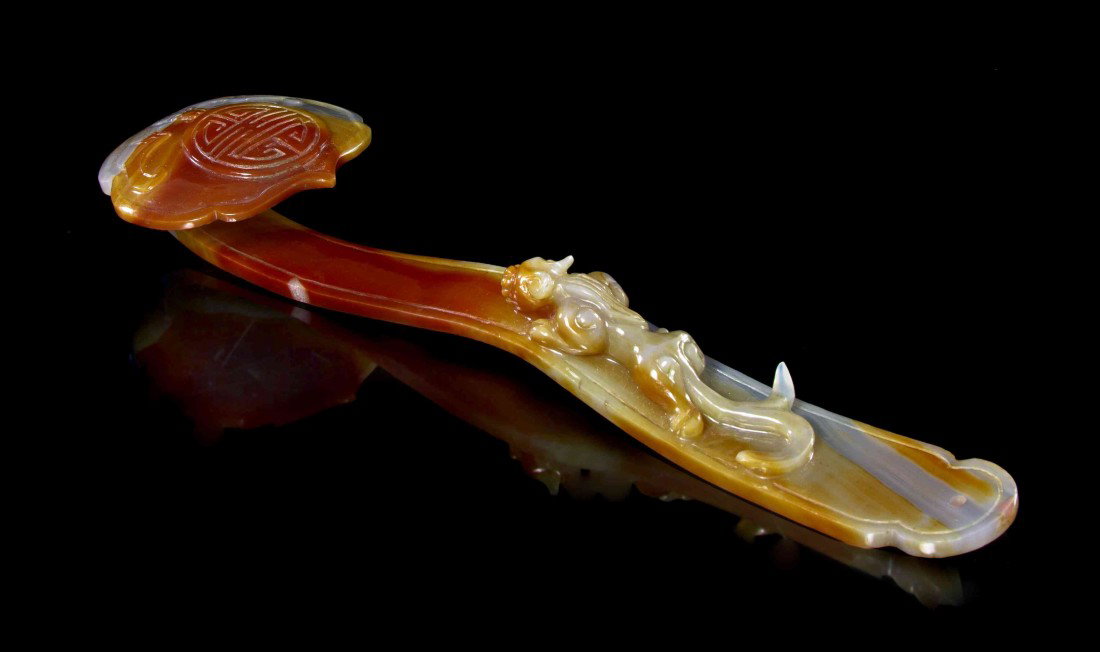 A Carved Agate Ruyi Scepter, Length 10 1/4 inches.: A Carved Agate Ruyi Scepter, of typical form, carved from a single stone, with a carved beast on the handle. Length 10 1/4 inches.