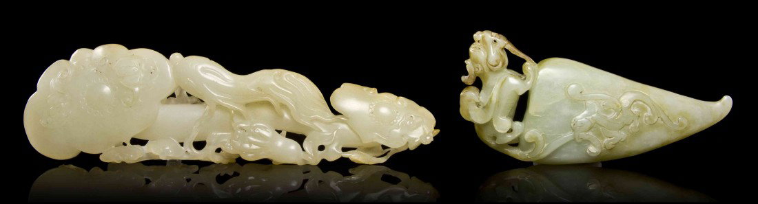 A Hardstone Ruyi Scepter and Toggle, Width of firs: A Hardstone Ruyi Scepter and Toggle, of pale celadon colored hardstone, depicting the scepter in rectangular form, with a toggle of horn form with a winged beast at top. Width of first 7 1/4 inches.
