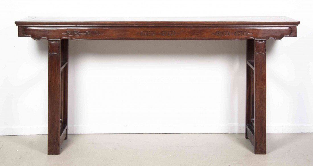 A Chinese Hardwood Altar Table, Height 39 x width : A Chinese Hardwood Altar Table, having a rectangular top above the carved apron with geometric relief decoration, raised upon four legs with carved cartouche at the top, joined by stretchers. Height 3