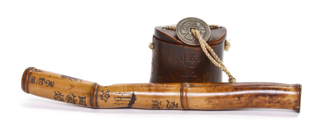 A Bamboo Pipe-Case or Kiseruzutsu, Length 8 1/8 in: A Bamboo Pipe-Case or Kiseruzutsu, the senryu-zutso having open top with carved characters throughout, with wood tobacco pouch. Length 8 1/8 inches.